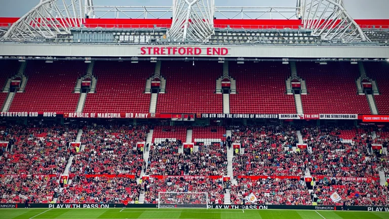 Crowd gathered at the Stretford End inside Old Trafford during a football match.