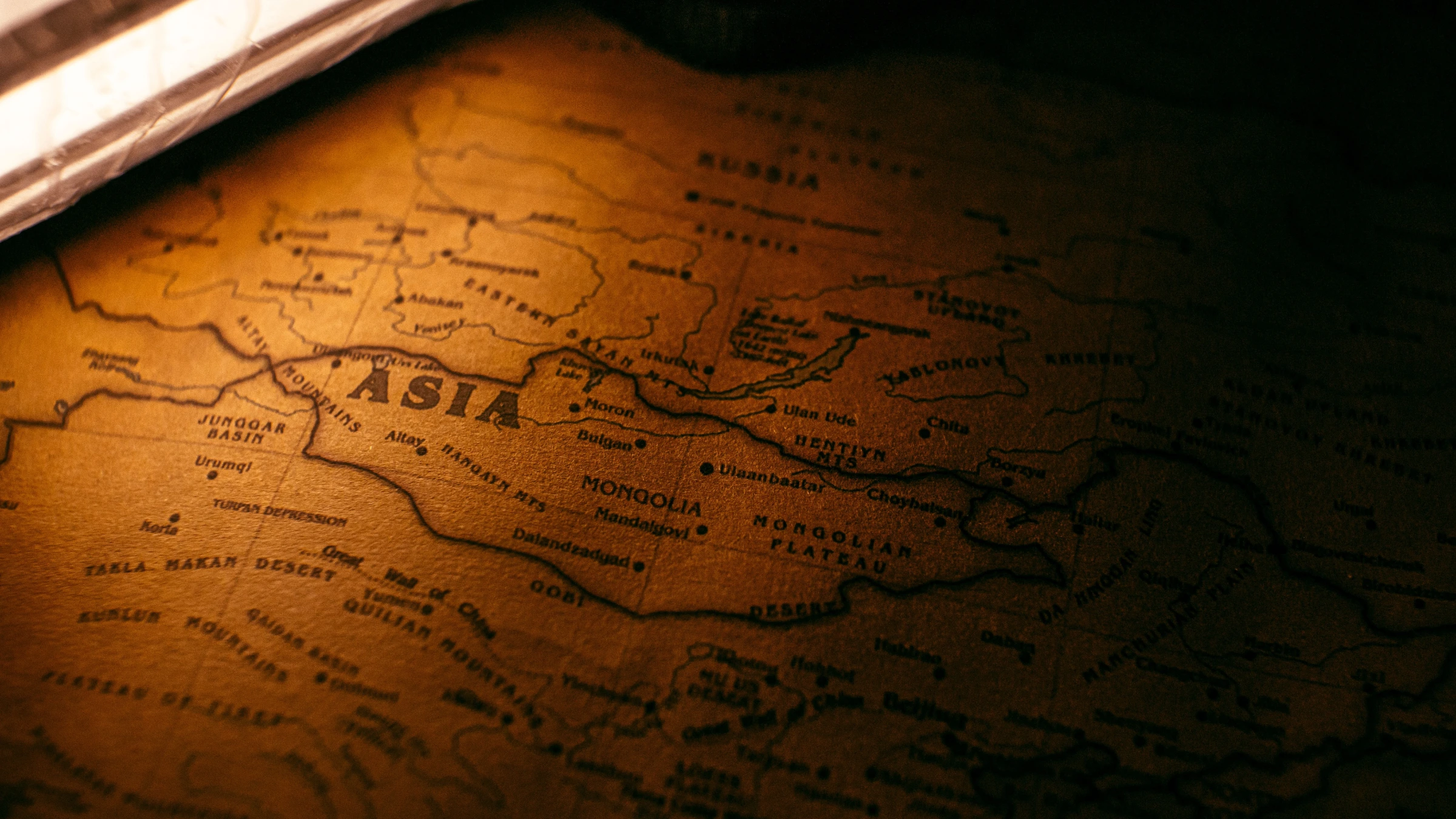 Vintage map highlighting Asia, Mongolia, Russia and surrounding countries under warm ambient lighting