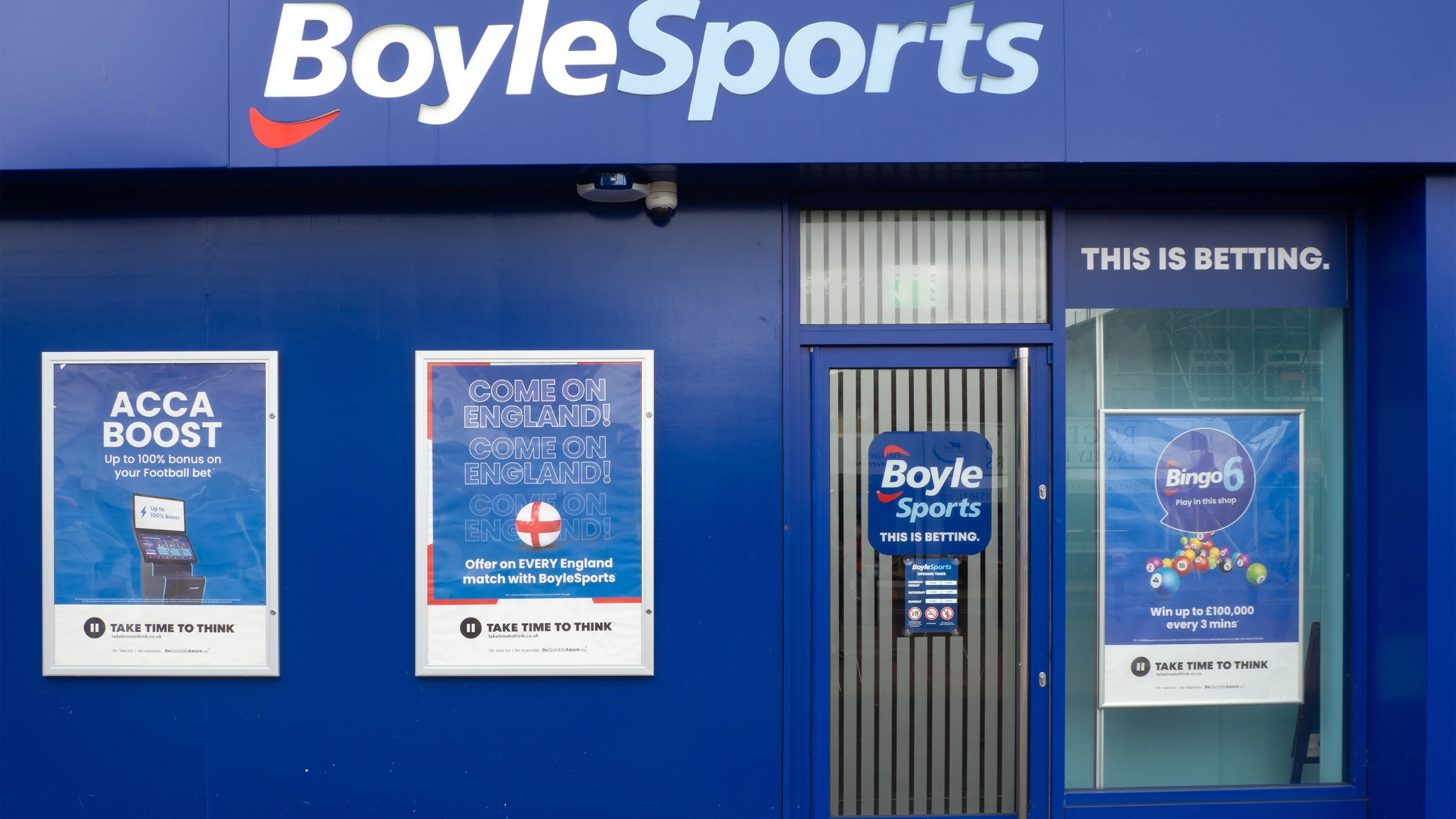 Front entrance of BoyleSports betting shop with sports betting promotional posters displayed outside
