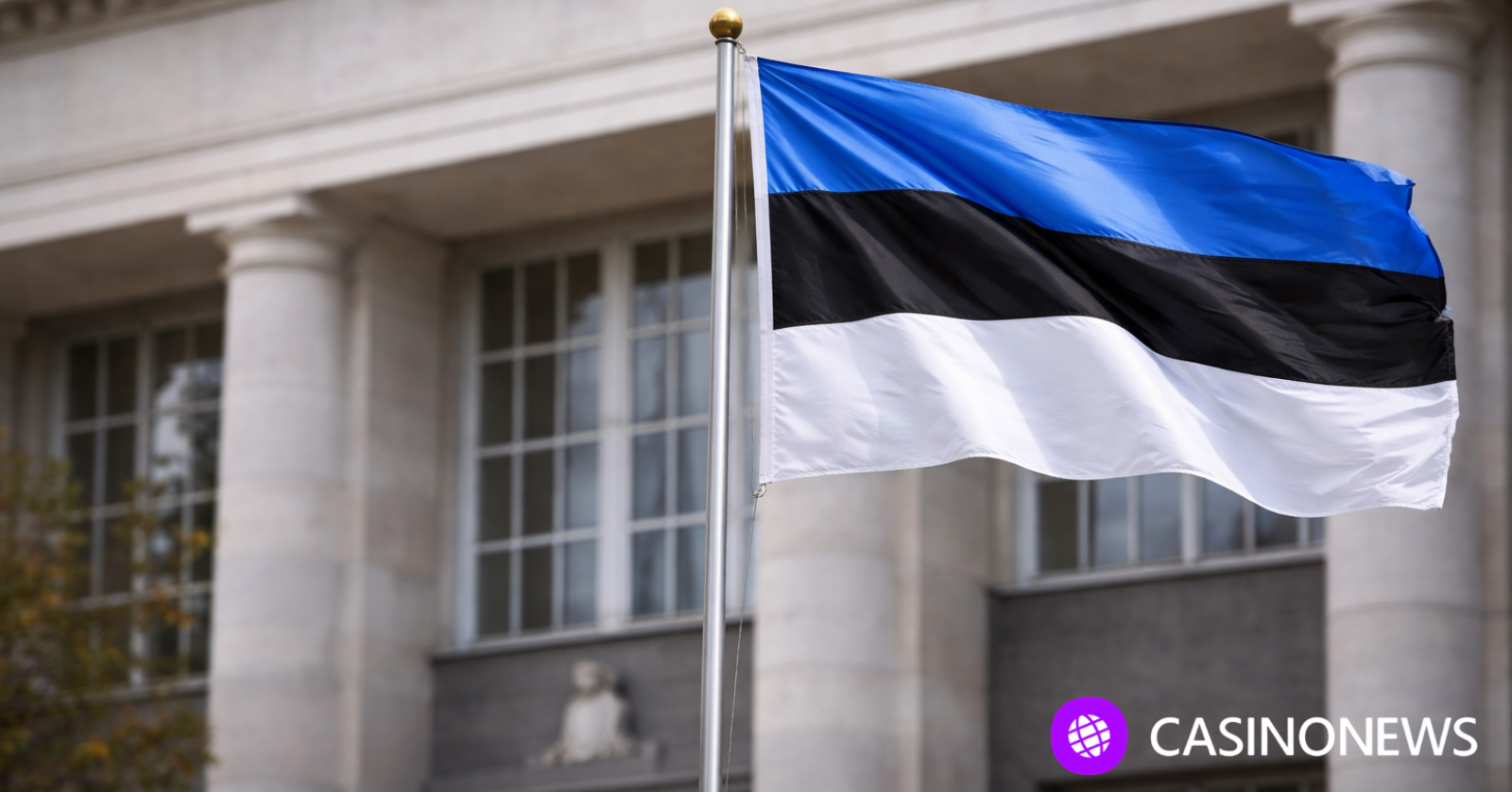 Estonian flag in front of a government-style building, illustrating Estonia’s gambling tax error and the voluntary payments made by remote operators.