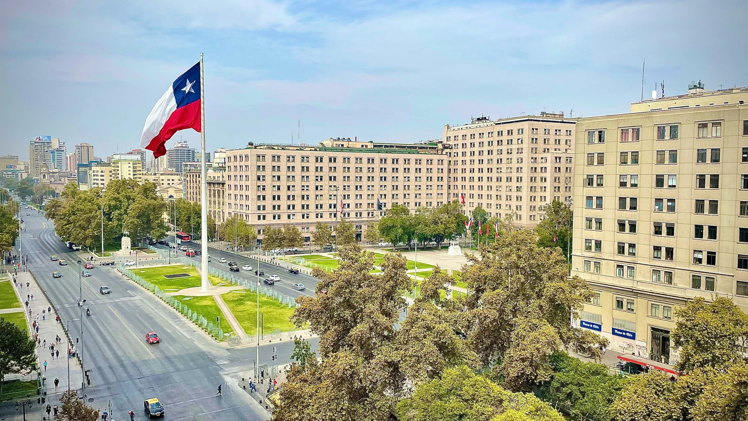Large Chilean national flag displayed above central Santiago city streets and government buildings