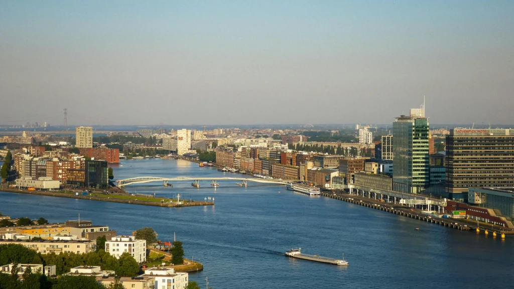 Wide aerial view of Amsterdam waterfront and Dutch urban skyline