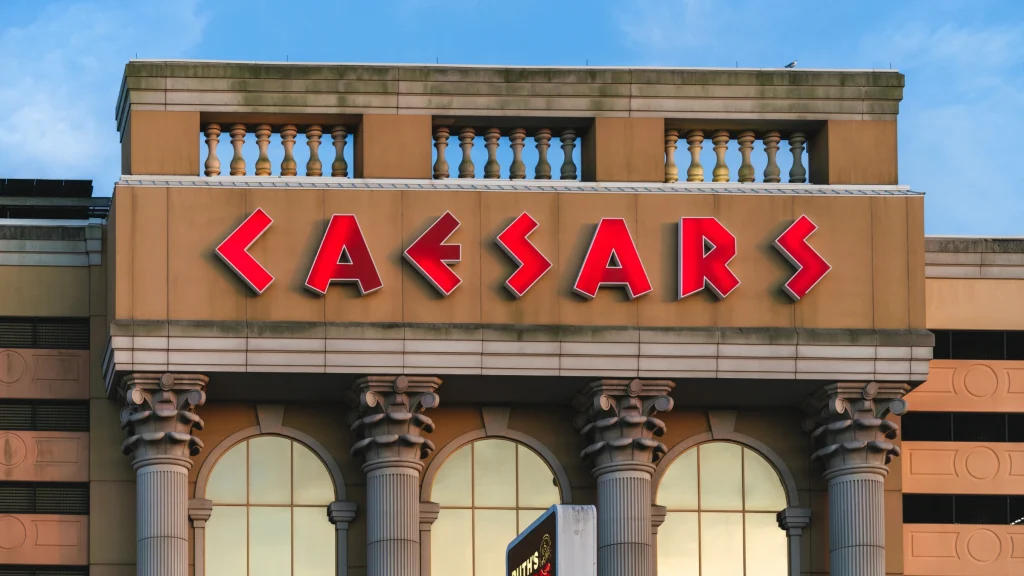 Caesars casino building exterior featuring large illuminated brand signage on facade