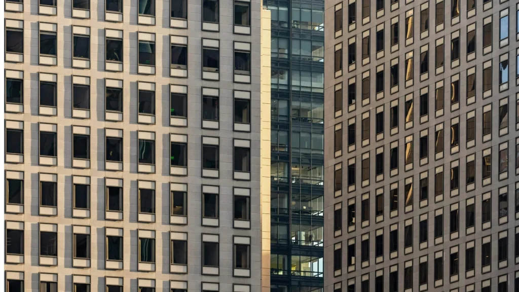 Modern office building facades with rows of windows in an urban setting.
