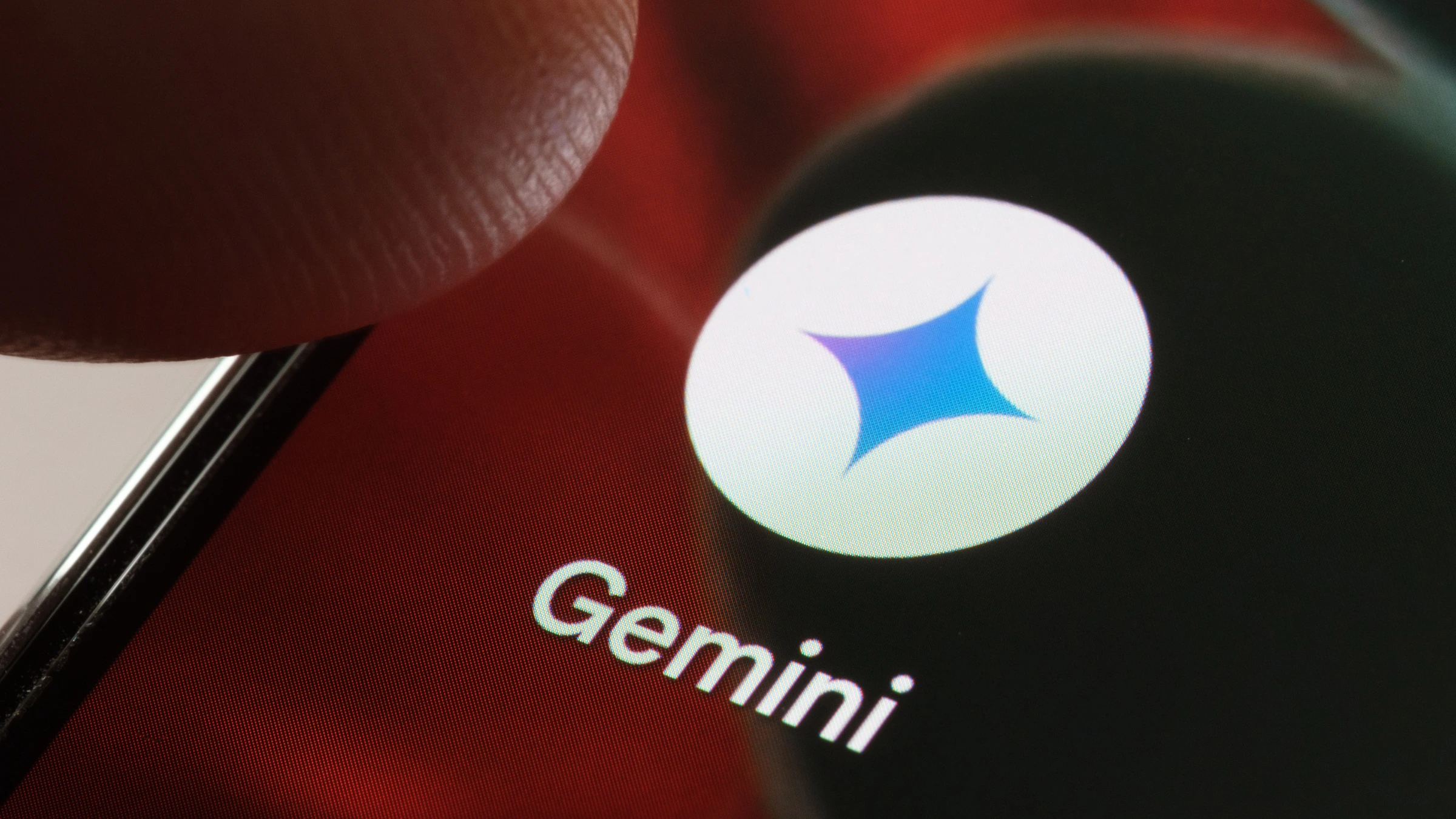 Close-up of Gemini application logo on smartphone screen with user interaction