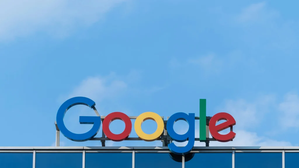 Google logo displayed on top of a modern office building