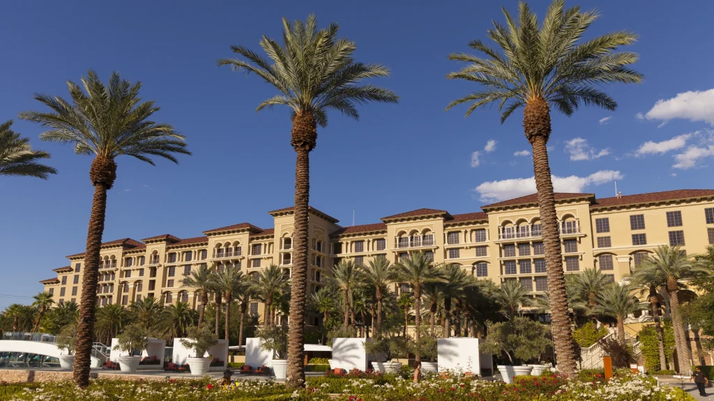 Resort hotel building surrounded by palm trees and landscaped outdoor areas