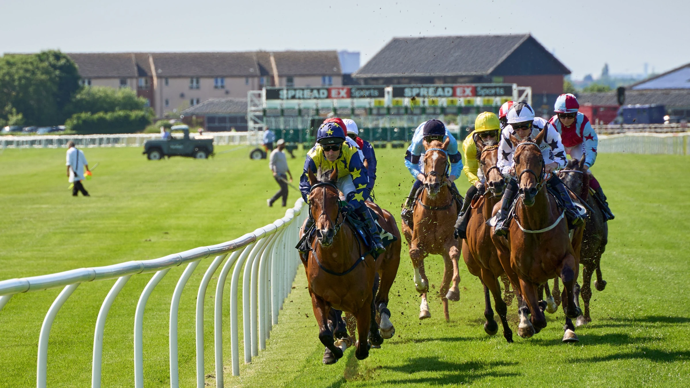 Horse racing competitors rounding track during discussion of wagering market changes