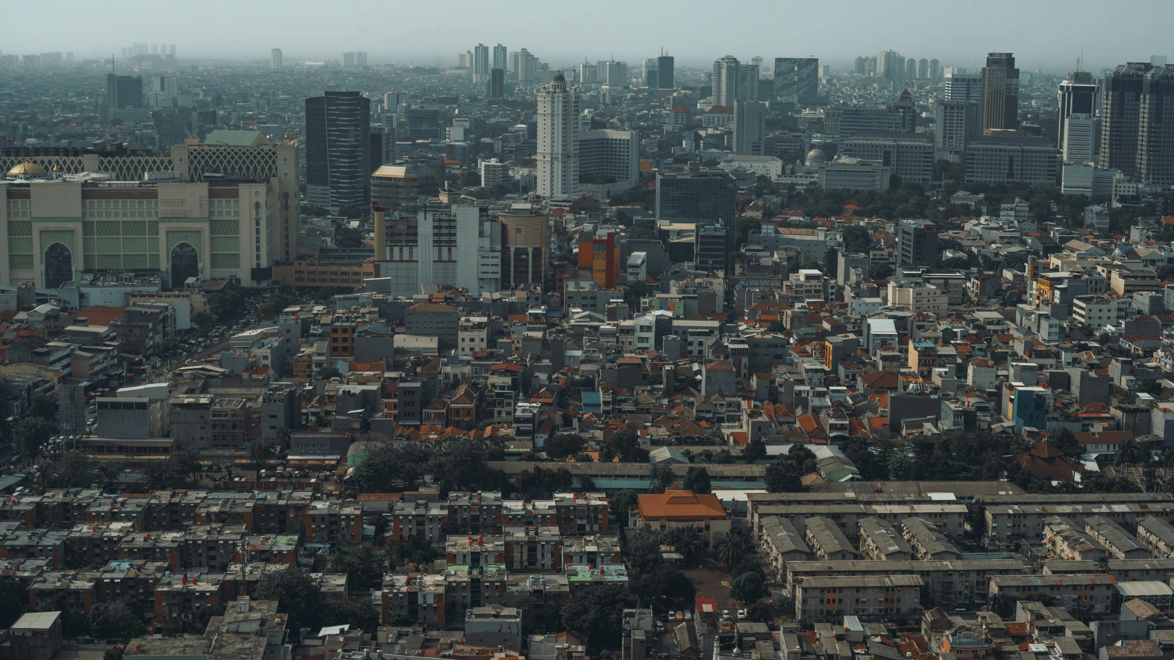 Aerial view of Jakarta skyline with dense urban buildings and high-rise towers across the city