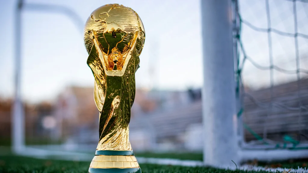 FIFA World Cup trophy on football field linked to betting and prediction market activity