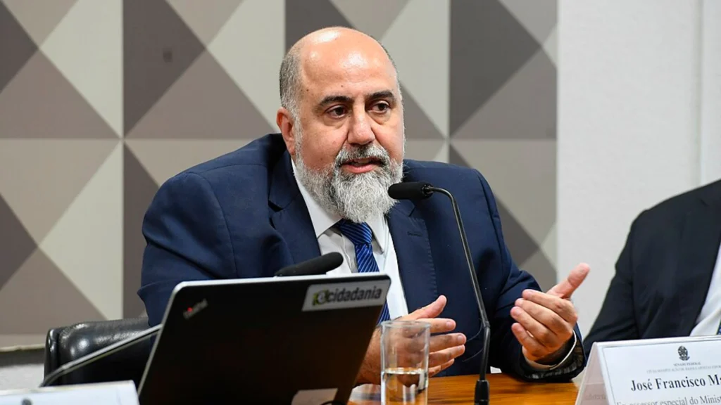 Government official speaking into microphone during public policy meeting and hearing