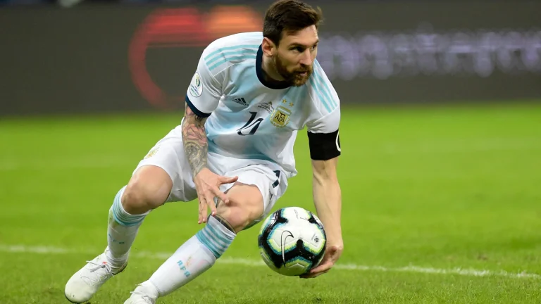 Professional football player controlling ball during international match on grass pitch