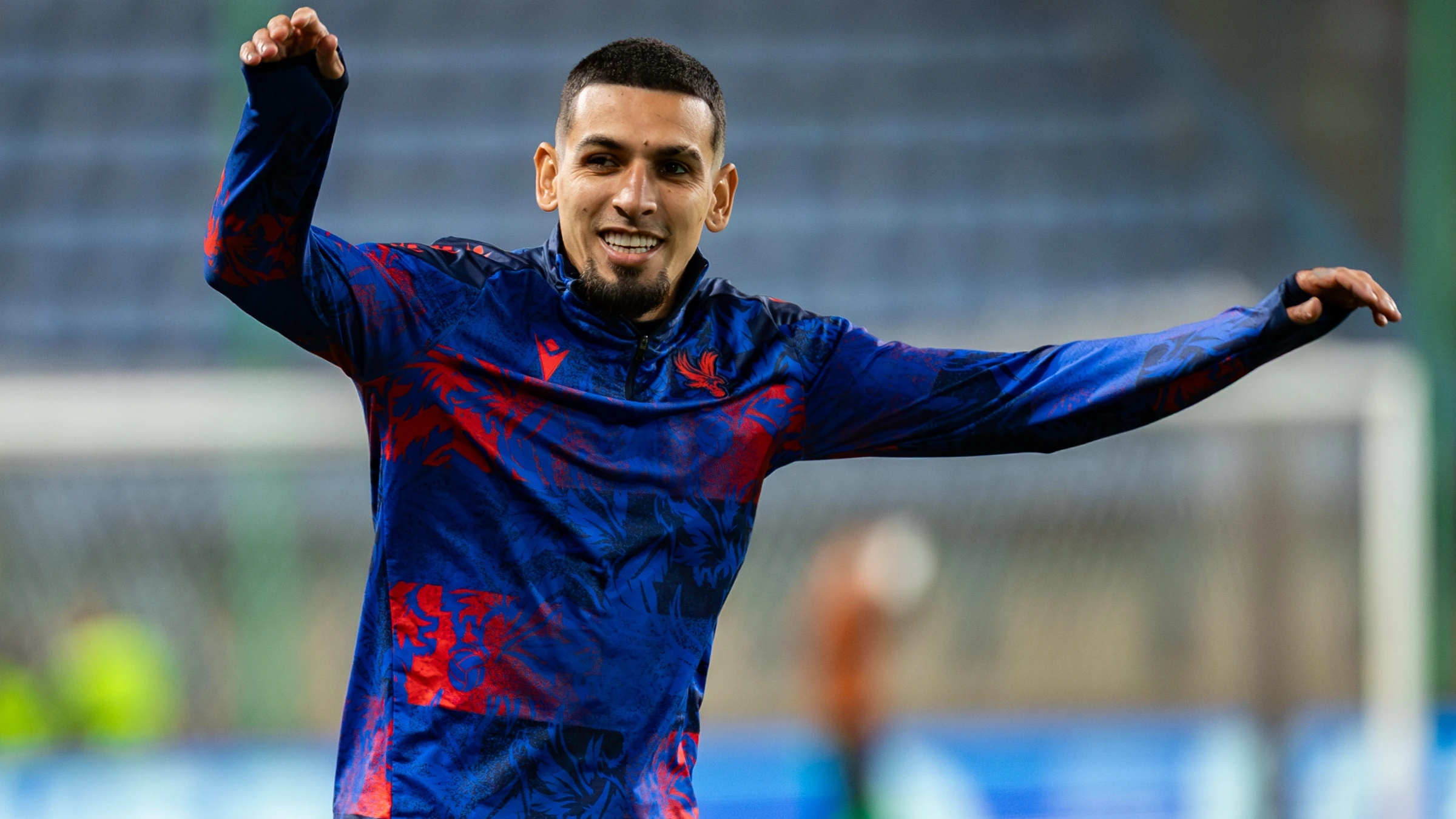 Football player warming up during training session before competitive match