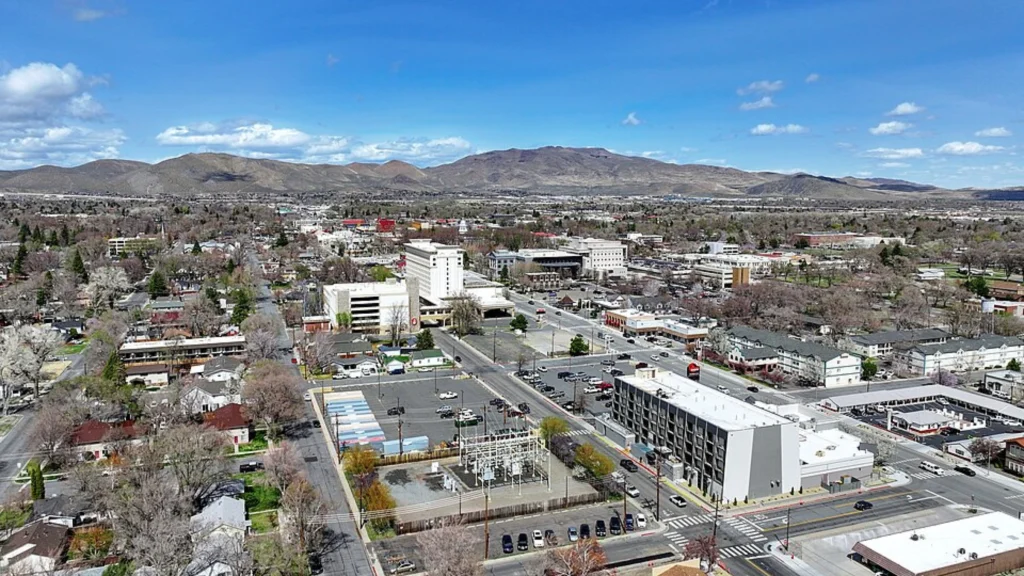 Nevada urban skyline with commercial buildings, roads and mountains under clear sky