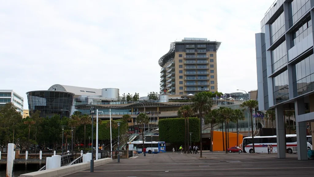 Modern waterfront business district with commercial buildings, hotel and public promenade