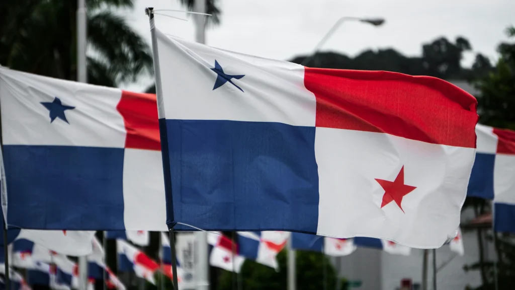 Panama national flags waving outdoors along roadway in urban setting