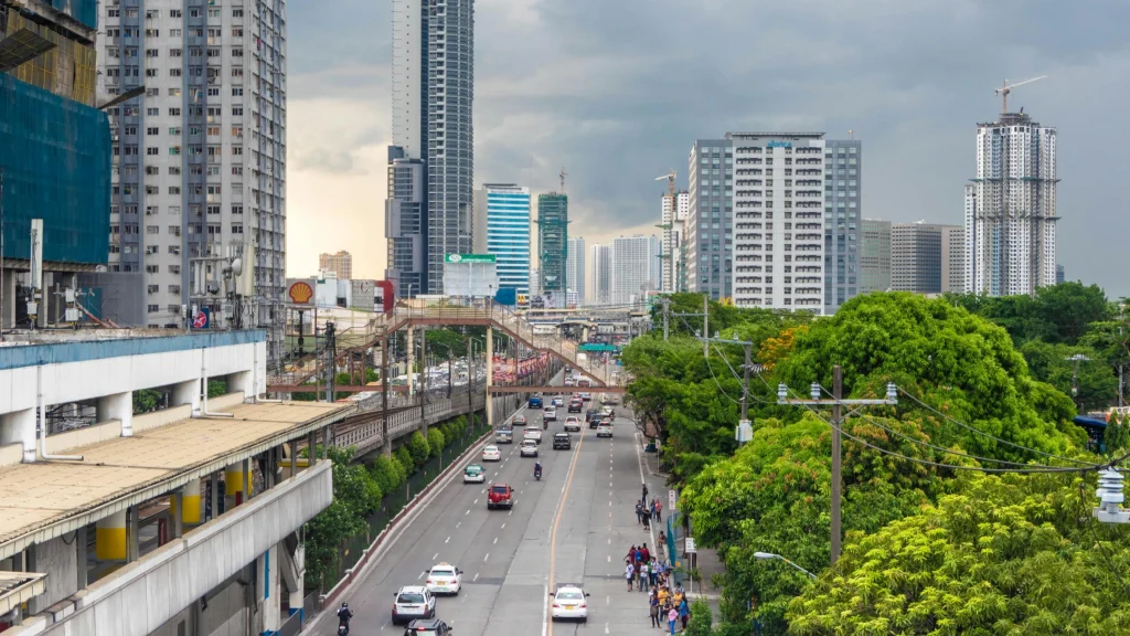 Urban skyline in the Philippines with traffic, rail infrastructure and high-rise buildings