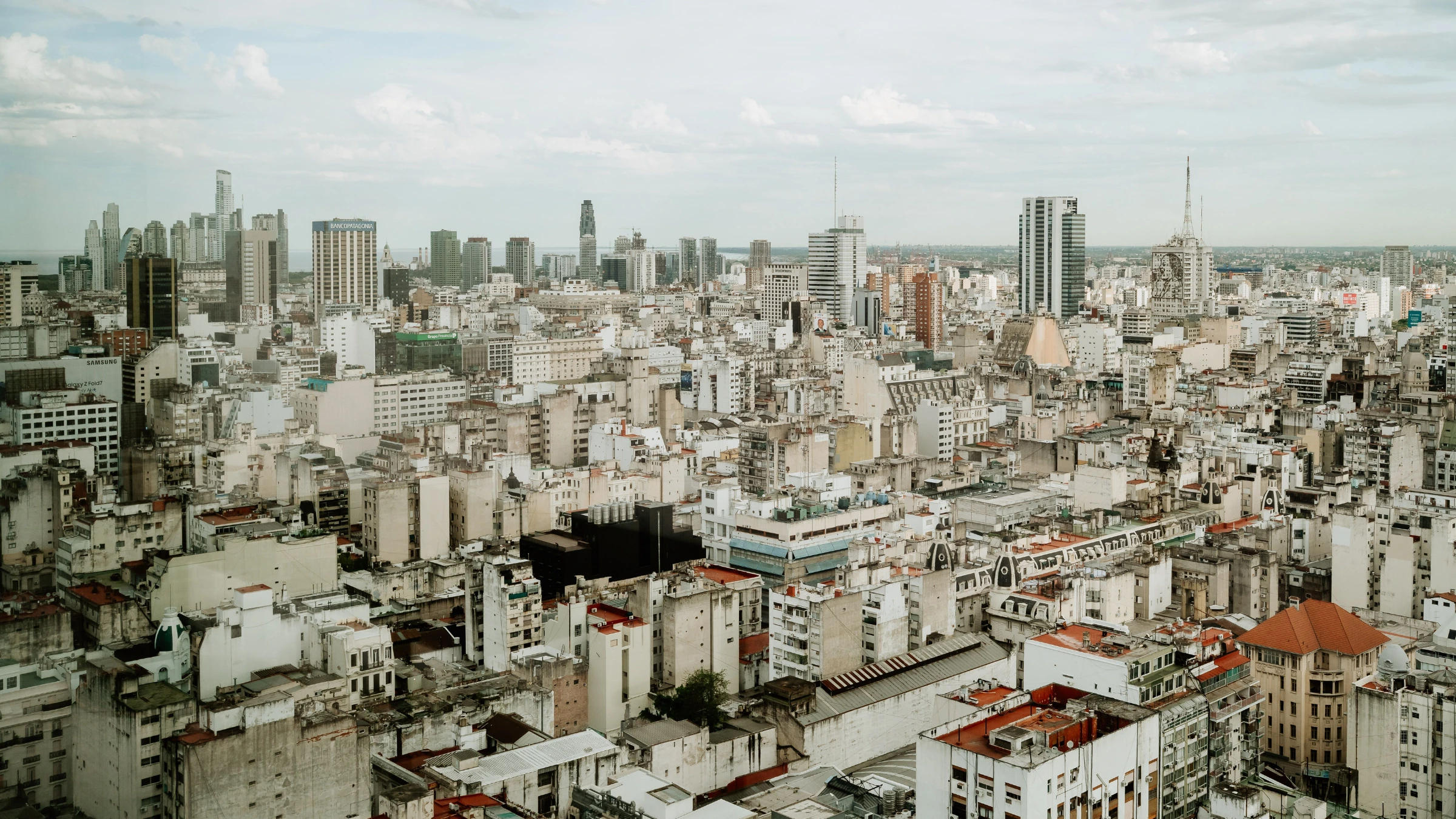 Panoramic view of Buenos Aires skyline featuring commercial buildings and residential districts under cloudy skies