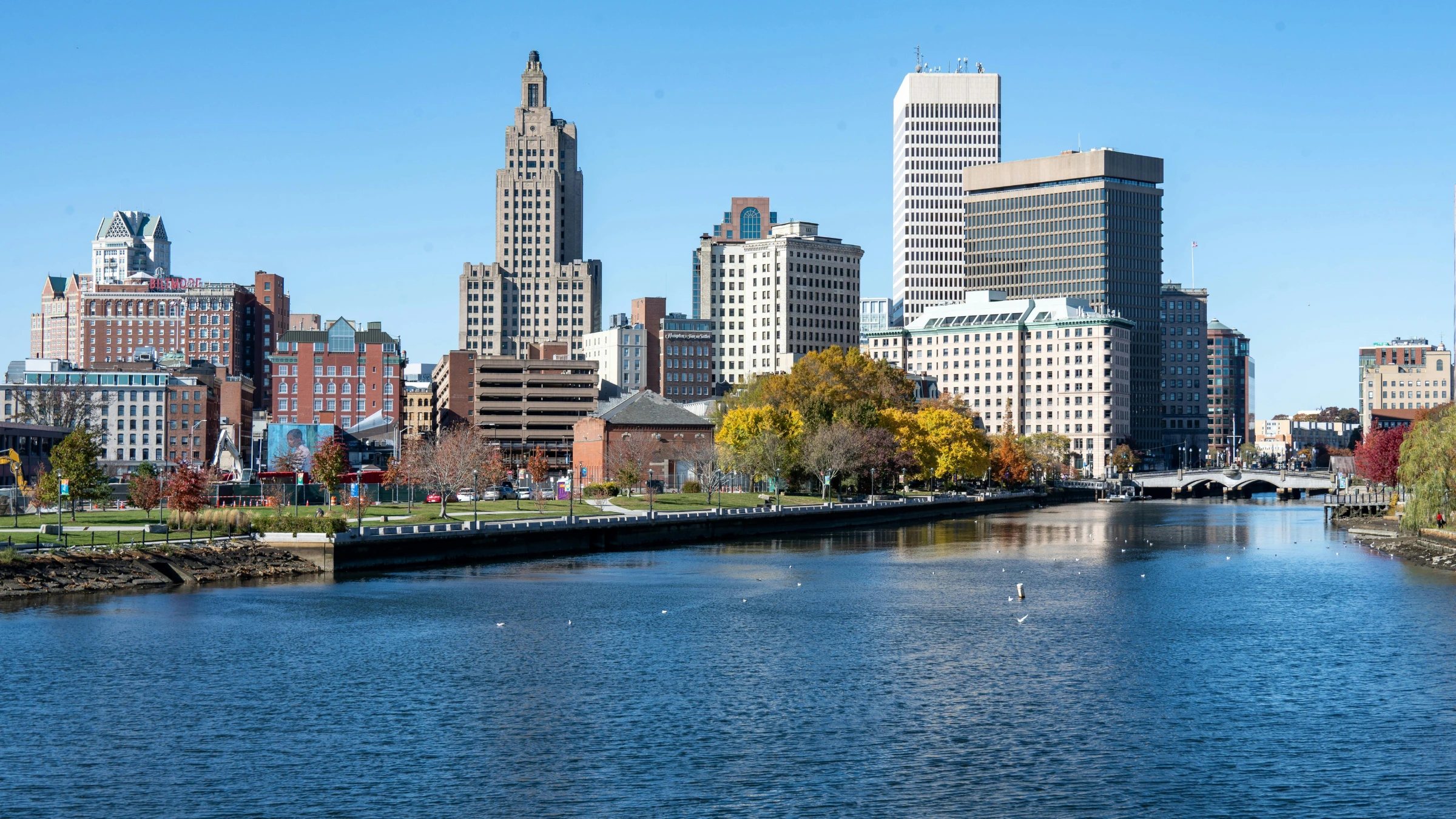 Providence Rhode Island skyline with waterfront buildings and river under clear blue sky