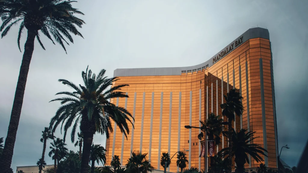 Mandalay Bay resort and casino building viewed from Las Vegas Strip with palm trees