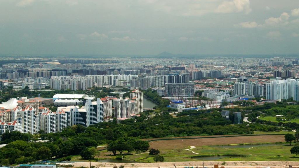 Aerial panorama of Singapore skyline featuring residential towers and urban development