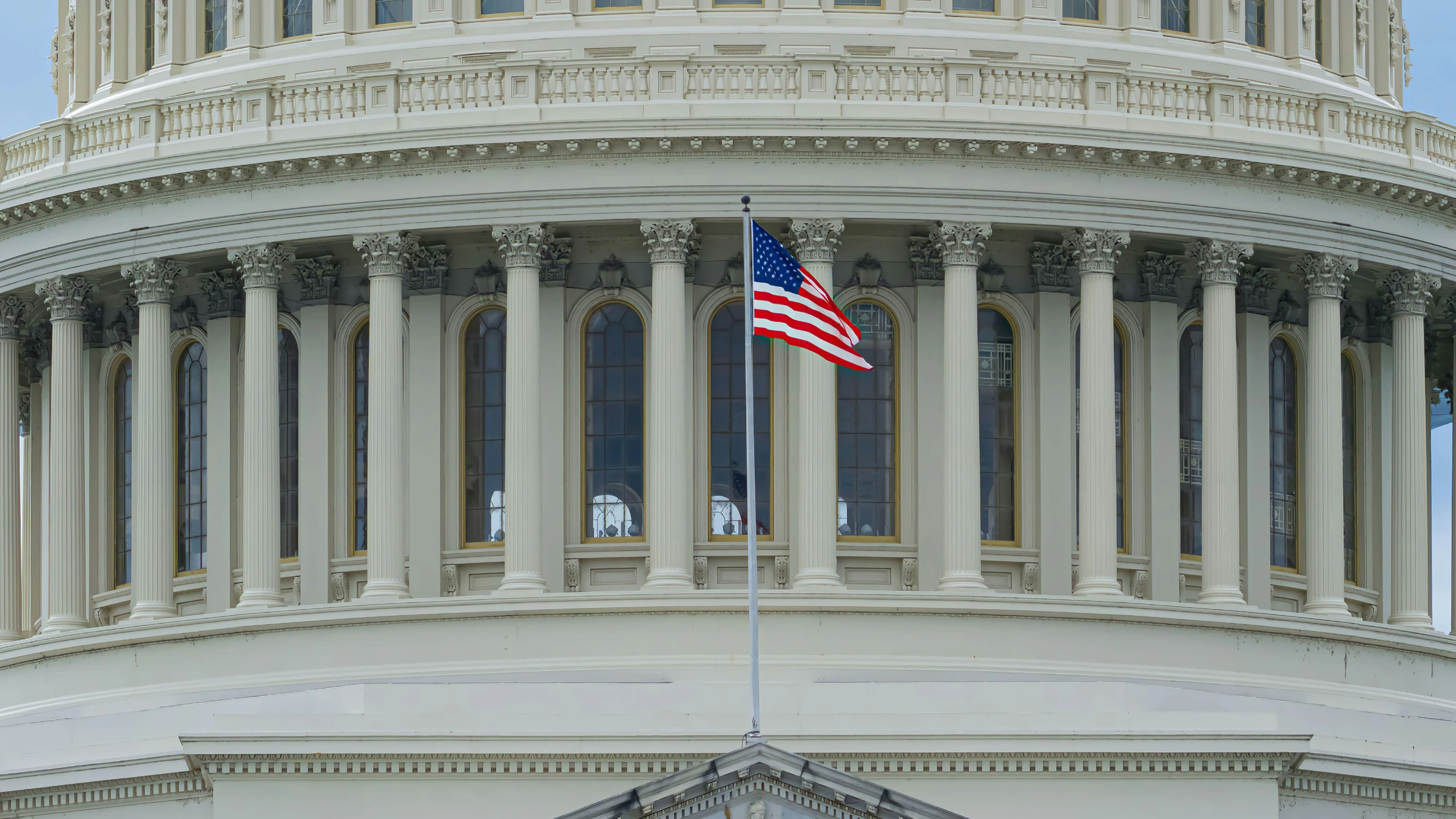 United States Capitol building with American flag waving prominently