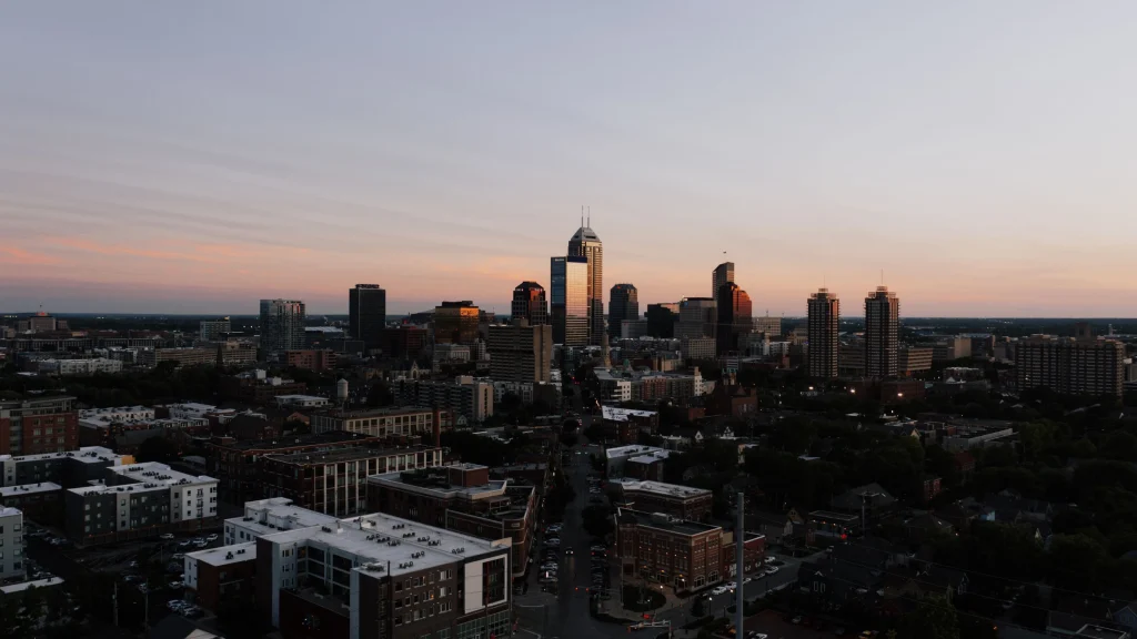 Indianapolis skyline at sunset with downtown office buildings and city streets