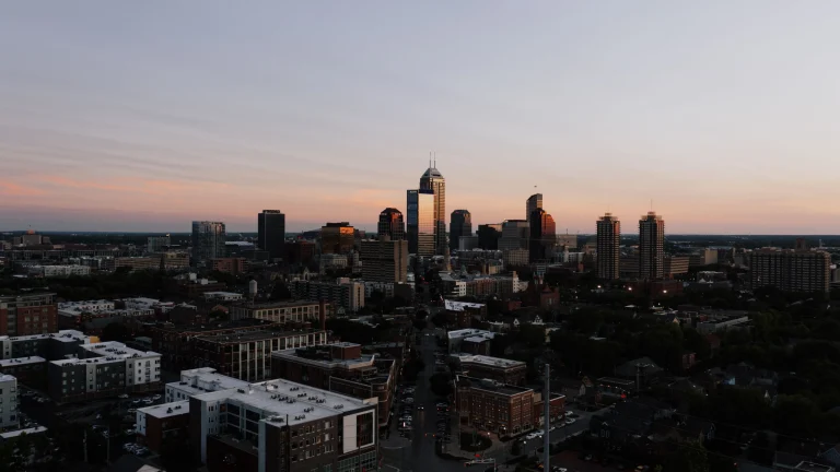 Indianapolis skyline at sunset with downtown office buildings and city streets