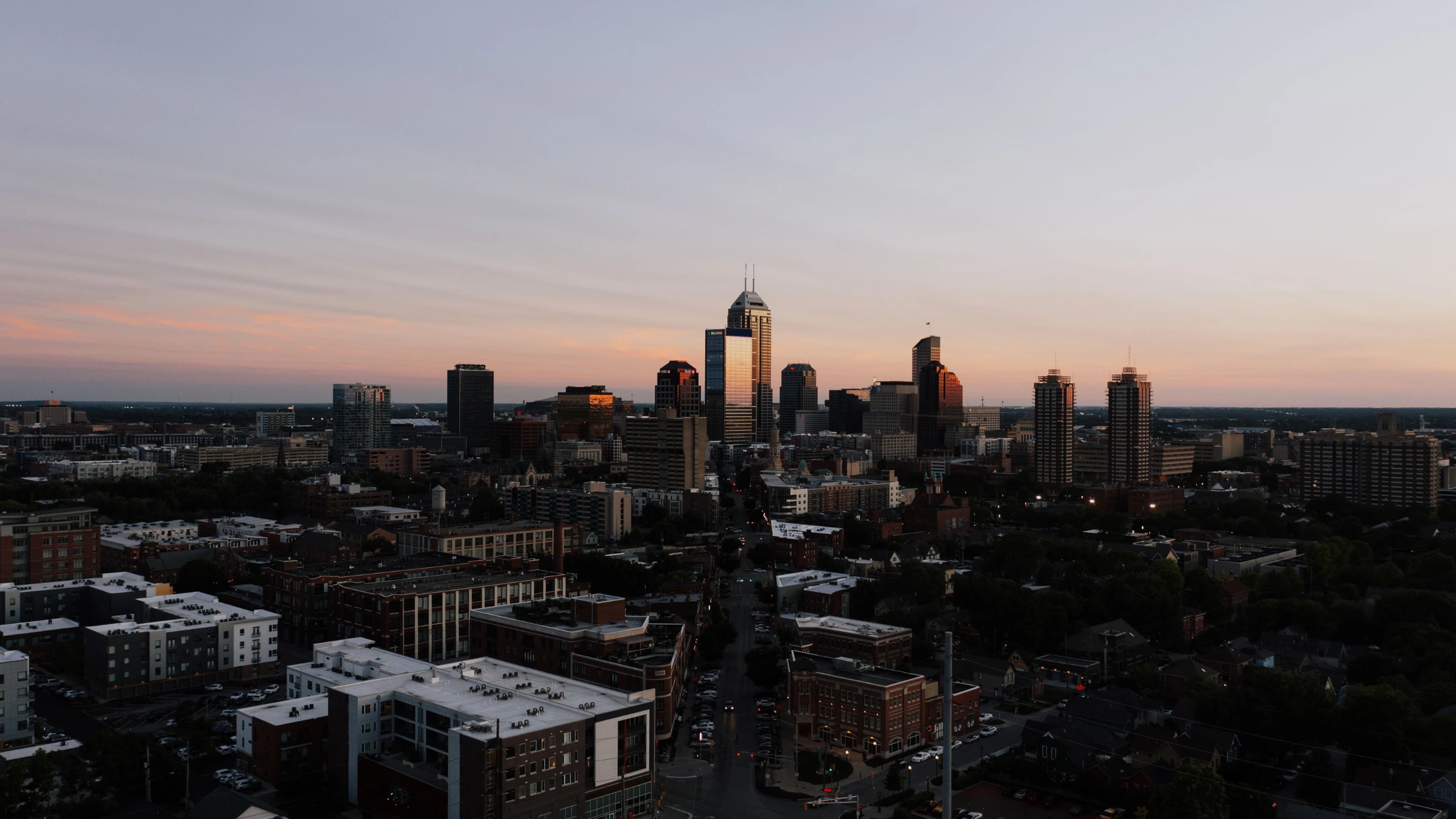 Indianapolis skyline at sunset with downtown office buildings and city streets
