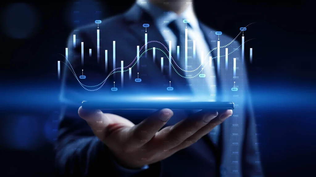 Businessperson holding digital tablet with glowing financial charts and market data graphics displayed