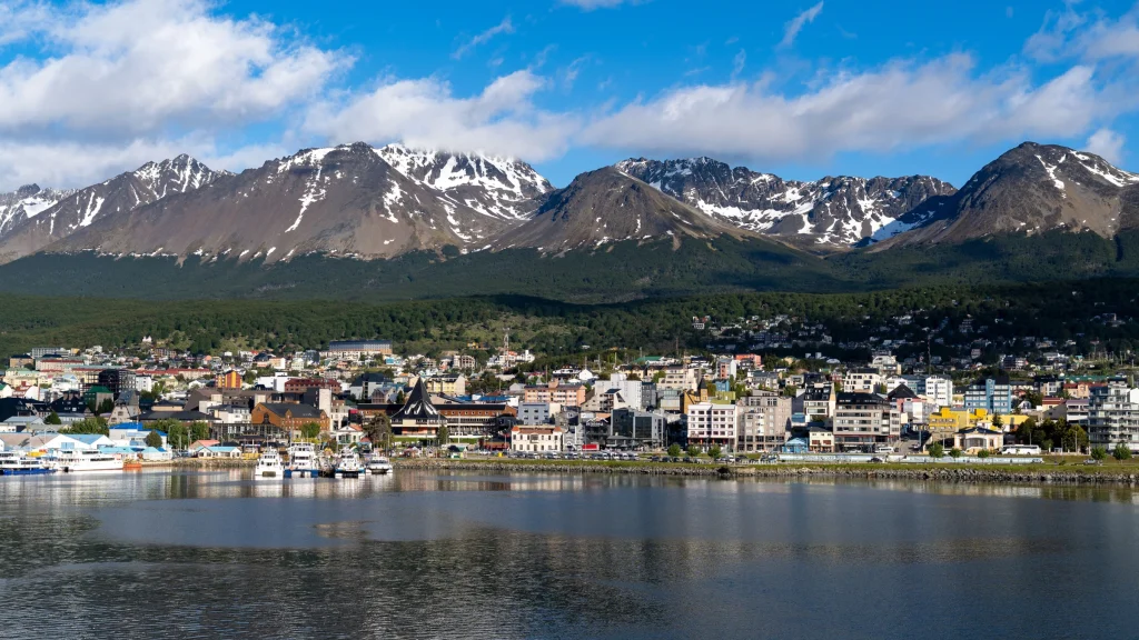 Tierra del Fuego cityscape with waterfront and snow-capped mountain range backdrop
