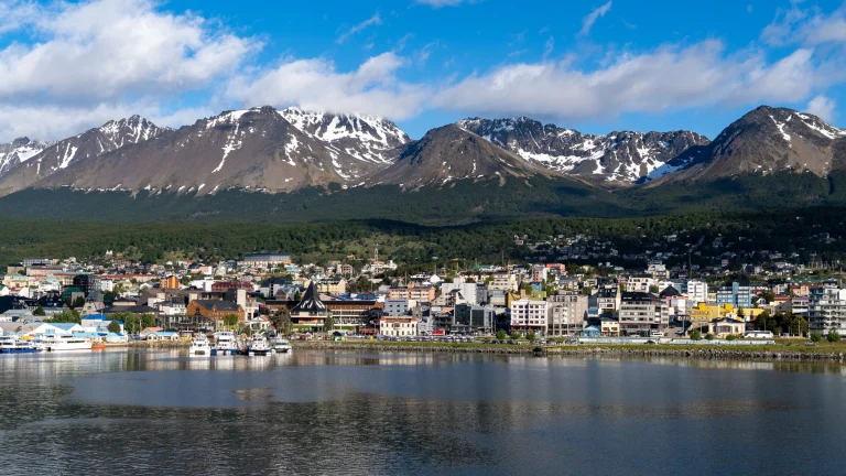 Tierra del Fuego cityscape with waterfront and snow-capped mountain range backdrop