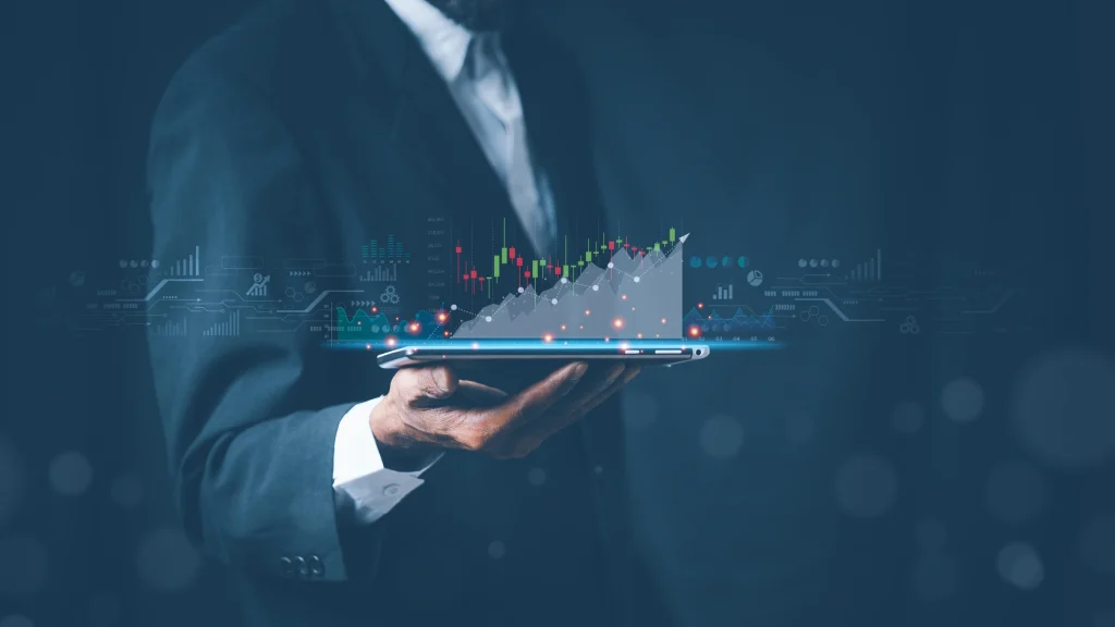 Business professional holding tablet displaying digital financial market growth chart