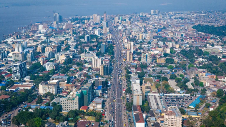 Aerial view of coastal city skyline with major roadway and waterfront