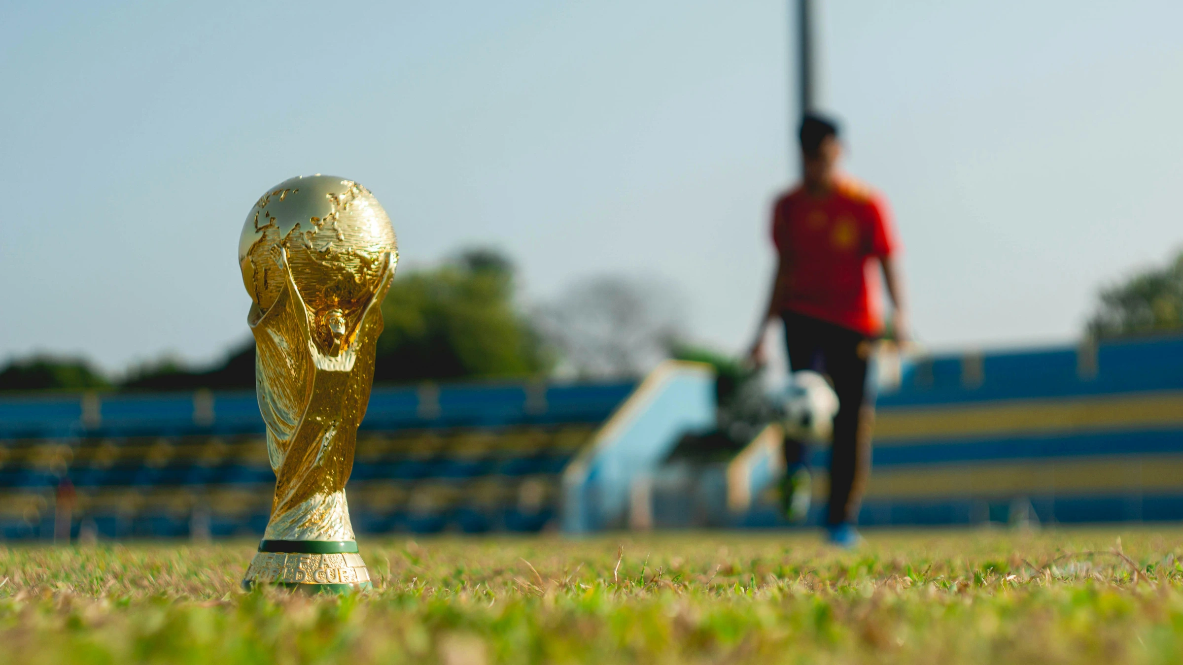 FIFA World Cup trophy displayed on football field before major tournament