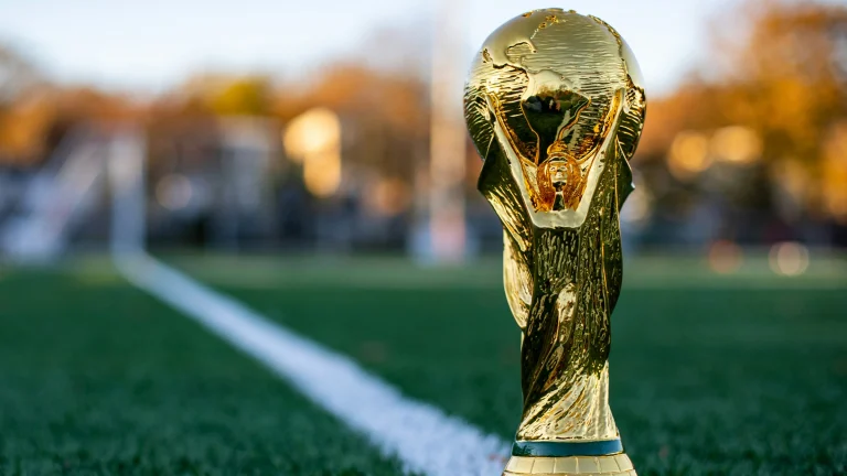 FIFA World Cup trophy displayed on football pitch before international tournament